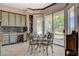 Charming breakfast nook in kitchen with decorative table, chairs, and scenic golf course views at 10562 Cerotto Ln, Las Vegas, NV 89135