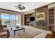 Inviting living room featuring a fireplace, custom shelving, and sliding glass doors to the backyard at 10562 Cerotto Ln, Las Vegas, NV 89135