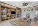 Cozy living room with custom built-ins, a fireplace, and views of the outdoors at 10562 Cerotto Ln, Las Vegas, NV 89135