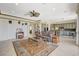 Spacious living room with tile floors, comfortable seating, and an open floor plan to the kitchen at 10562 Cerotto Ln, Las Vegas, NV 89135