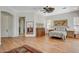 Spacious main bedroom with wood floors, a ceiling fan, and abundant natural light at 10562 Cerotto Ln, Las Vegas, NV 89135