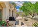 Outdoor kitchen area with a built-in grill and desert landscaping at 10562 Cerotto Ln, Las Vegas, NV 89135