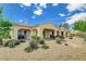 Rear exterior showcasing covered patio and backyard desert landscaping at 10562 Cerotto Ln, Las Vegas, NV 89135