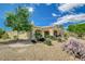 Back exterior view of the home with a patio and desert landscaping at 10562 Cerotto Ln, Las Vegas, NV 89135