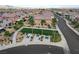 Aerial view featuring a community park with seating areas nestled among palm trees and homes at 1114 Junipine Ave, North Las Vegas, NV 89081