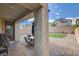 Backyard patio featuring a seating area, manicured lawn, and a view of the surrounding houses at 1114 Junipine Ave, North Las Vegas, NV 89081