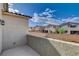 Charming balcony with views of the neighborhood residences under a sunny, cloud-filled sky at 1114 Junipine Ave, North Las Vegas, NV 89081