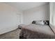 Neutral bedroom features carpeted floors, a window, and a queen bed at 1114 Junipine Ave, North Las Vegas, NV 89081