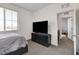 Bedroom features a neutral color palette and a television atop a dresser at 1114 Junipine Ave, North Las Vegas, NV 89081