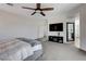 Spacious bedroom features a ceiling fan, a television, and carpeted floors at 1114 Junipine Ave, North Las Vegas, NV 89081