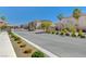 Gated community entrance showcasing landscaping and neighborhood homes under a clear blue sky at 1114 Junipine Ave, North Las Vegas, NV 89081