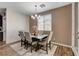 Elegant dining room with a modern chandelier, comfortable seating, and views of the neighborhood at 1114 Junipine Ave, North Las Vegas, NV 89081