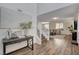 Inviting entryway with wood floors, staircase, modern console table and open access to living area at 1114 Junipine Ave, North Las Vegas, NV 89081