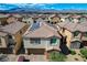 An aerial of a two story home with a desert landscape and mountain views at 1114 Junipine Ave, North Las Vegas, NV 89081