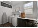 Laundry room featuring a front-load washer, a dryer, and a window at 1114 Junipine Ave, North Las Vegas, NV 89081