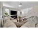 Inviting living room featuring a comfortable sectional sofa and a modern entertainment center at 1114 Junipine Ave, North Las Vegas, NV 89081