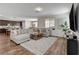 Open-concept living room featuring stylish decor, wood floors, and seamless flow to the kitchen at 1114 Junipine Ave, North Las Vegas, NV 89081