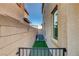 Functional side yard featuring artificial turf, an air conditioning unit, and secure fencing at 1114 Junipine Ave, North Las Vegas, NV 89081