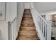 Staircase with a wooden steps and white railing leading to the upper level of the home at 1114 Junipine Ave, North Las Vegas, NV 89081