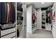 Spacious walk-in closet featuring multiple storage solutions, including shelves, drawers, and hanging rods at 1114 Junipine Ave, North Las Vegas, NV 89081