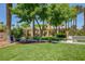 View of the community amenity center surrounded by lush landscaping and mature palm trees at 130 Twin Towers Ave, Las Vegas, NV 89123