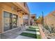 Inviting covered back patio with a ceiling fan, outdoor furniture, and desert landscaping at 130 Twin Towers Ave, Las Vegas, NV 89123