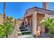 Desert landscaped back patio including white table and chairs with stripe accents at 130 Twin Towers Ave, Las Vegas, NV 89123