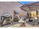 Outdoor patio area featuring a grill, seating, and an umbrella for shade at 130 Twin Towers Ave, Las Vegas, NV 89123