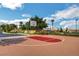 Community basketball court with mature trees, green space and tennis court in the background at 130 Twin Towers Ave, Las Vegas, NV 89123