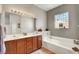 Relaxing bathroom with soaking tub, double sinks, and ample cabinet space for storage at 130 Twin Towers Ave, Las Vegas, NV 89123