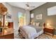 Bedroom with olive green accent wall, neutral bedding and ceiling fan at 130 Twin Towers Ave, Las Vegas, NV 89123