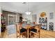 Bright dining room boasts an open concept, wood floors, and stylish pendant lighting for a modern design at 130 Twin Towers Ave, Las Vegas, NV 89123
