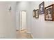Neutral hallway with tile floor and a series of framed artwork on the wall at 130 Twin Towers Ave, Las Vegas, NV 89123