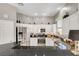 Well-lit kitchen with stainless steel appliances, black countertops, and white cabinets at 130 Twin Towers Ave, Las Vegas, NV 89123