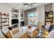 Cozy living room showcasing a fireplace, comfortable seating, and backyard views through sliding glass doors at 130 Twin Towers Ave, Las Vegas, NV 89123