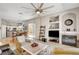 Open-concept living space with fireplace, tv and seamless flow into the dining area and kitchen at 130 Twin Towers Ave, Las Vegas, NV 89123