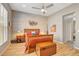 Beautifully decorated main bedroom with wood-look accent wall, wood floors, and ample natural light at 130 Twin Towers Ave, Las Vegas, NV 89123