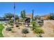 Neighborhood park with American flag and playground with shade structures in a desert landscape at 130 Twin Towers Ave, Las Vegas, NV 89123