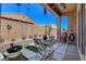 Covered patio with pavers, wind chimes, and desert landscaping at 130 Twin Towers Ave, Las Vegas, NV 89123