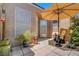 Comfortable patio area with shade umbrella and desert landscaping at 130 Twin Towers Ave, Las Vegas, NV 89123