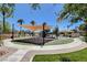 Well-maintained playground with shade structure, swings and mature landscaping in a park setting at 130 Twin Towers Ave, Las Vegas, NV 89123