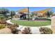Community playground with shade structures, and walking paths through a landscaped setting at 130 Twin Towers Ave, Las Vegas, NV 89123