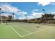 A full view of a well-maintained community tennis court with lighting for night play at 130 Twin Towers Ave, Las Vegas, NV 89123