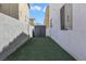 Narrow backyard features artificial turf and storage shed at 1316 Oak Village Ave, Las Vegas, NV 89183
