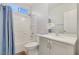Bathroom features a shower-tub combo, single sink, and light gray cabinetry at 1316 Oak Village Ave, Las Vegas, NV 89183