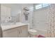 Well-lit bathroom with a shower-tub combination and a speckled shower curtain at 1316 Oak Village Ave, Las Vegas, NV 89183