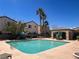 Community pool with lounge chairs and shaded seating areas at 1316 Oak Village Ave, Las Vegas, NV 89183