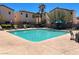 Community pool with lounge chairs and lush landscaping at 1316 Oak Village Ave, Las Vegas, NV 89183