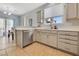 Open kitchen features stainless steel dishwasher, light gray cabinets and overlooks the dining area at 1316 Oak Village Ave, Las Vegas, NV 89183