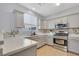Kitchen with stainless steel appliances, gray cabinets, quartz countertops, and tile backsplash at 1316 Oak Village Ave, Las Vegas, NV 89183